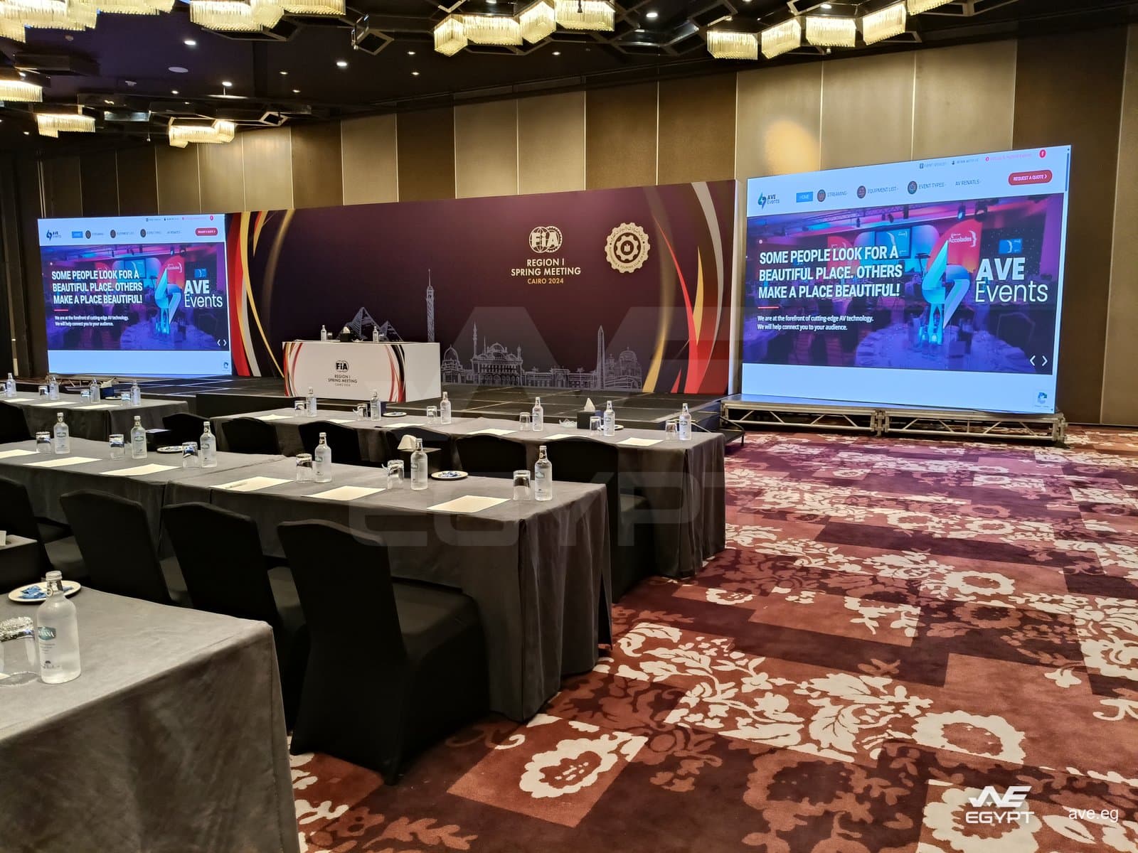 FIA Region I Spring Meeting: the branded top table on stage between the two screens
